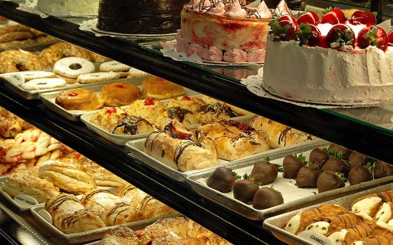 The bakery case at Lancers Diner, filled with danish, éclairs, cannoli and strawberry-topped cakes